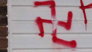Swastika sprayed on door