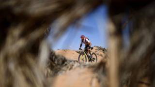Competitors ride their bikes during Stage 6 of the 14th edition of Titan Desert 2019 mountain biking race between El-Jorf and Erfoud in Morocco on May 3, 2019.