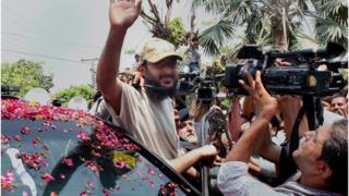 Ali Haidar Gilani, son of former Pakistani Prime Minister Yusuf Raza Gilani waves to media upon arrival at his residence in Lahore, Pakistan, Wednesday 11 May 2016.