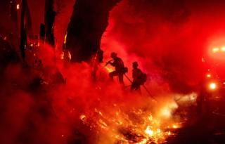 Fire-fighters work to control flames from a backfire during the Maria fire in Santa Paula, California on 1 November 2019.