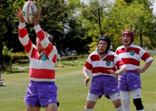 Members of Tokyo's Fuwaku Rugby Club train outdoors