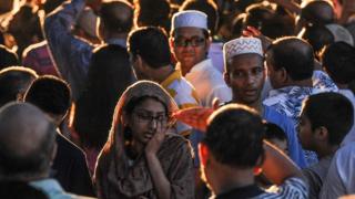 A crowd of community members gather at the place where Imam Maulama Akonjee was killed in the Queens borough of New York City, August 13, 2016