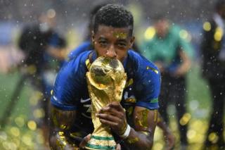 France's defender Presnel Kimpembe kisses the World Cup trophy after winning the Russia 2018 World Cup final football match between France and Croatia at the Luzhniki Stadium in Moscow on July 15, 2018.