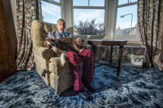 Man sits with a dog