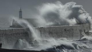Waves crashing against the sea wall in Newhaven during Storm Isha