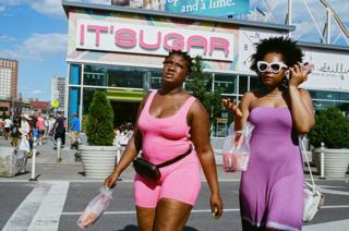 Two women are seen out shopping in the street