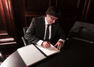 Catalan President Carles Puigdemont signs the bill into law, 6 September