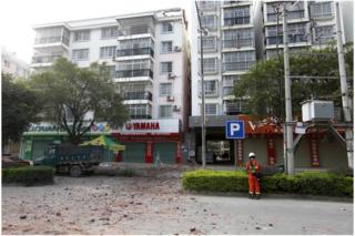A Chinese firefighter stands at the scene of an explosion in Liucheng county in southern China's Guangxi Zhuang Autonomous Region Thursday, 1 October 2015