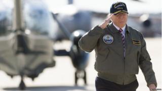 US President Donald Trump salutes as he walks to Air Force One