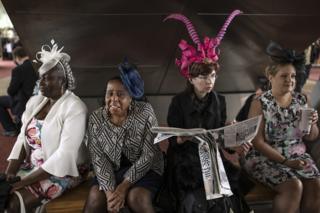 Four women take a break on the first day of races at Ascot Racecourse on 18 June 2019 in Ascot, England.