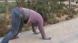 A woman crawling on the ground