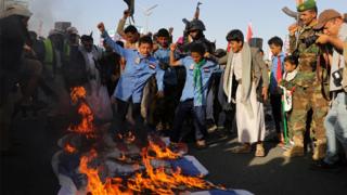 Crowd burns a flag in Sanaa