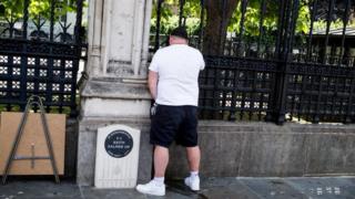 A man appearing to urinate on PC Keith Palmer's memorial