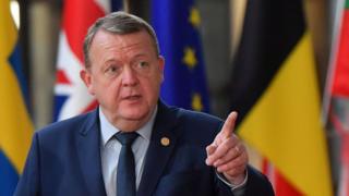 Danish Prime Minister Lars Lokke Rasmussen makes gestures when he arrives at the Brussels European Council on 18 October 2018