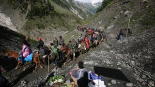 Indian Hindu pilgrims cross mountain trails during their religious journey to the Amarnath cave