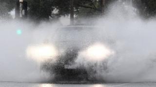 A car travels drives through heavy rain in Australia