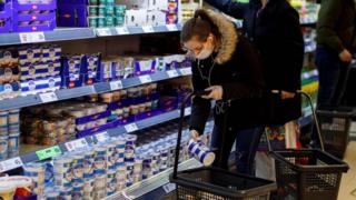 Woman shopping in London supermarket