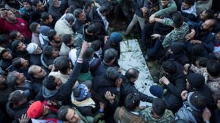 Mourners attend the burial of Qasem Soleimani