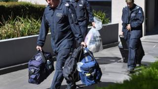 Police officers remove evidence from the Italian consulate in Melbourne