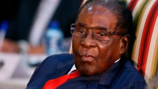 Robert Mugabe ontop chair