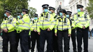 Police officers at an anti-lockdown protest in London