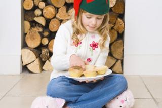 Girl with a plate of mince pies