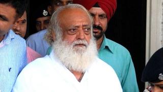 ndian spiritual guru Asaram Bapu (C) is escorted by police, after he was arrested from his Indore ashram, at the airport in Jodhpur on September 1, 2013