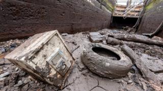 A safe and a tyre in a drained canal lock