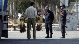 Gaza security personnel inspect goods which have been brought across from Israel