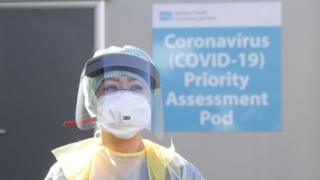 A healthcare worker wearing PPE in a hospital