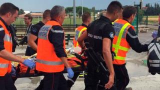 Firemen take a badly injured passenger to a helicopter to be airlifted to hospital (17 Aug)