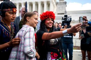 Climate activist Greta Thunberg poses for a selfie with Panamanian climate activist Militza Flaco outside the US Supreme Court in Washington DC, USA. 18 September 2019