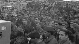 In March 1944 Denis Johnston, BBC War Correpondent visited Yugoslavian Partisans on an island off the coast of Yugoslavia. Recordings were made of a march past nad of songs and speeches.Partisans listening to playback of their march past recordings. Copyright BBC
