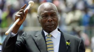 In this file photo taken on October 09, 2001 Kenyan president, Daniel Arap Moi, waves to the crowd while he enters in the National Stadium to celebrates Moi day in Nairobi Kenya 10 October, 2001.