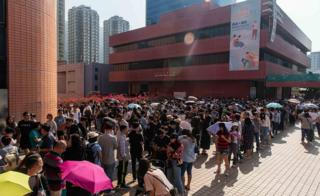 People line up at a polling station to vote in the Tuen Man District Council elections on November 24, 2019 in Hong Kong