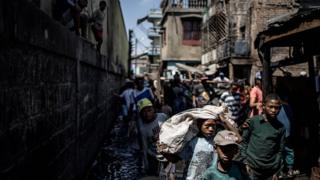 Residents trying to salvage their belonging from a fire that ravaged overnight a section of the Anosibe central market in Antananarivo.