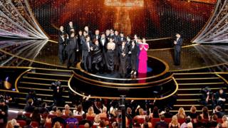 The cast and crew of Parasite accept their Oscar for best picture