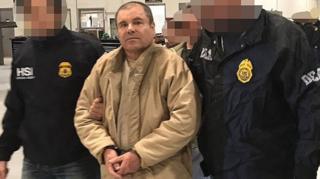 photo taken on January 19, 2017 This handout picture released by the Mexican Interior Ministry shows Joaquin Guzman Loera aka "El Chapo" Guzman (C) escorted in Ciudad Juarez by the Mexican police as he is extradited to the United States