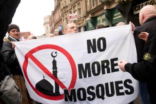 Protesters hold a banner reading No More Mosques during a demonstration by the UK branch of the German group Pegida in Newcastle upon Tyne in 2015