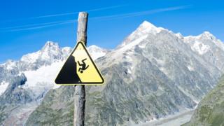 Slippage danger sign with Miage Glacier and Combal peaks in the background, August 2014