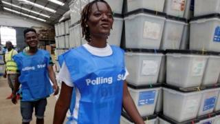 lection workers dey waka pass ballot boxes and voting materials for National Electoral Commission headquarters wey dey Monrovia, Liberia