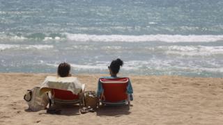 People sunbathe in Arenal beach on June 16, 2020 in Palma de Mallorca (June 2020)