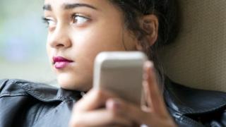 Teenager using smartphone