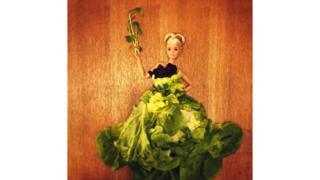 A doll dressed in lettuce