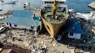This aerial photograph taken on October 3, 2018 shows a passenger ferry that was washed ashore into buildings in Wani, Indonesia's Central Sulawesi, after an earthquake and tsunami hit the area on September 28.