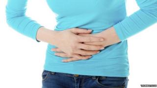 Woman clutching stomach in pain