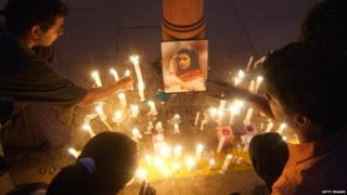 Indian protesters light candles around a photographs of murdered woman Jessica Lal during a protest at India Gate in New Delhi, 04 March 2006.
