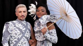 Local fashionistas George Lambrou (L) and Goodness Anele (R) pose for a portrait during the 2018 edition of the Vodacom Durban July in Durban, on July 7, 2018.