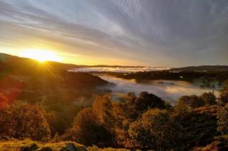 Mist and sun over trees at Elterwater