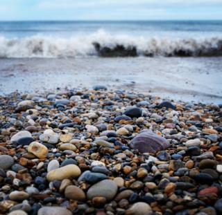 Waves crashing on pebbles